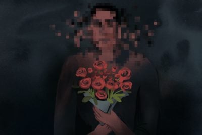 Person holding bouquet of flowers, with face blurred.