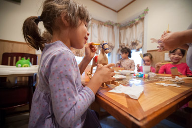 Belle Rembis, 6, paints a Christmas present for a family member in Texas. (Jeffrey Sauger for ProPublica)